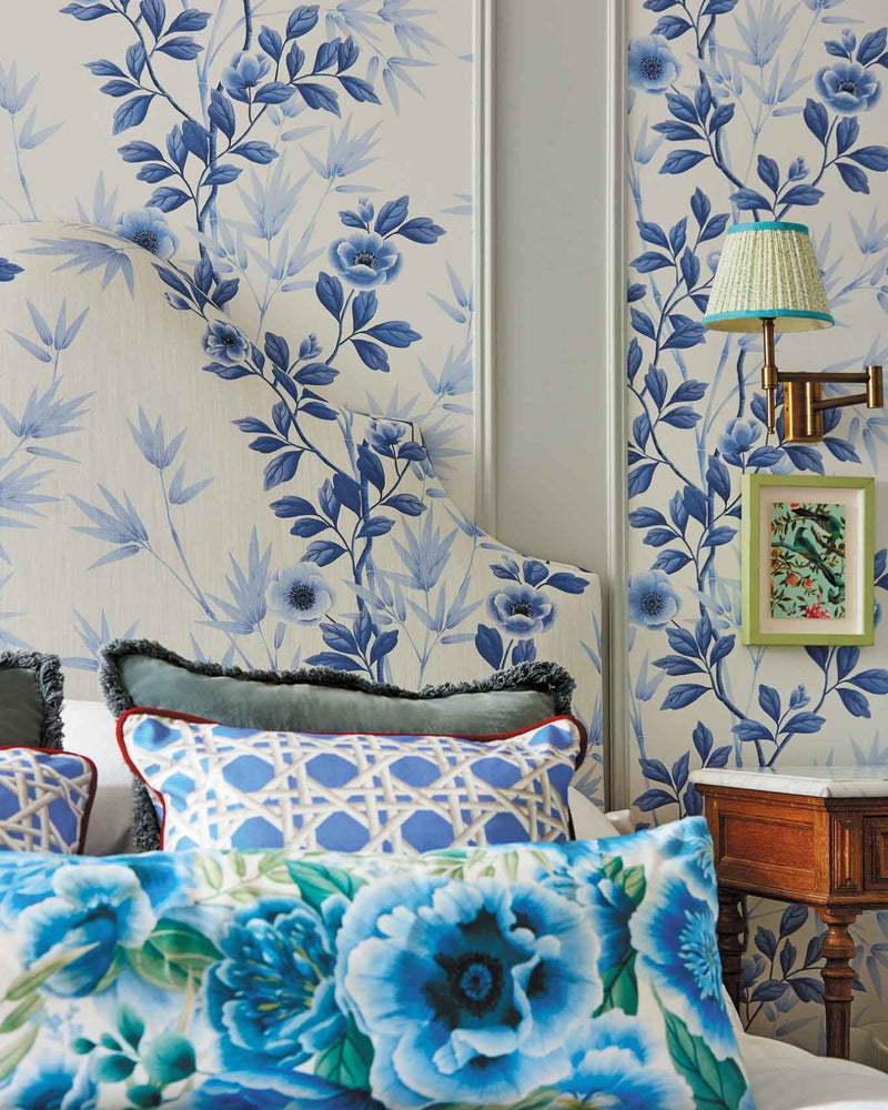 classic blue and white chinoiserie wallpaper featuring bamboo and flowers in regency style bedroom