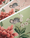 close up of pink and green chinoiserie art prints featuring butterflies and flowers with 24 carat gold embellishements