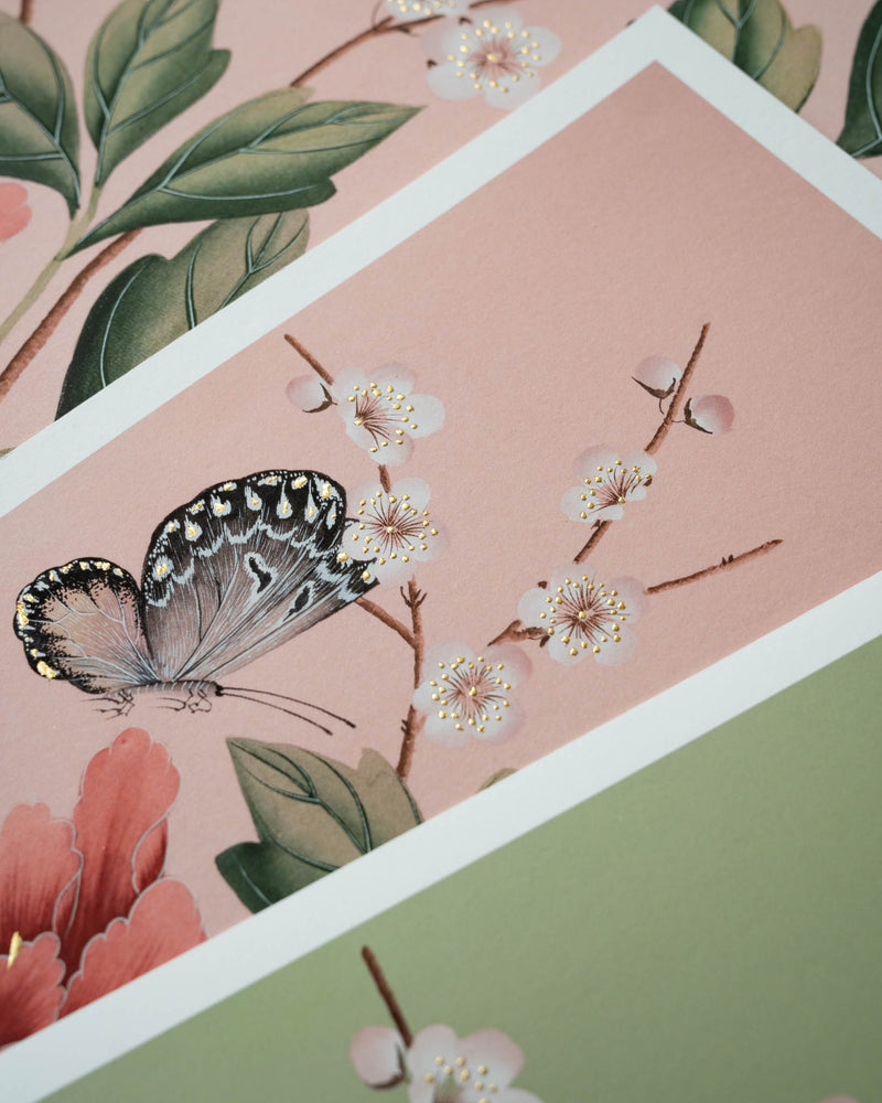 close up of pink and green chinoiserie art prints featuring butterflies and flowers with 24 carat gold embellishements