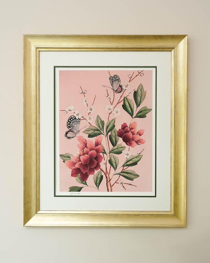 framed pink chinoiserie art print featuring red flowers, cherry blossoms, and butterflies on wall