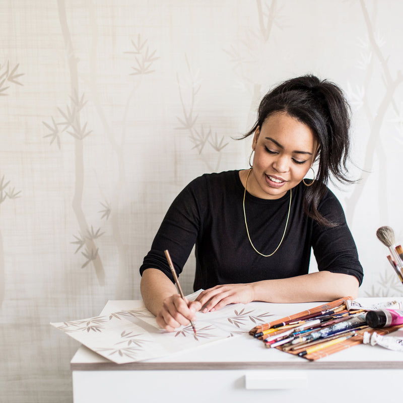 Chinoiserie artist Diane Hill at home in her London studio painting bamboo leaves by hand
