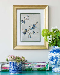 framed chinoiserie wall art print featuring Japanese-style cherry blossom branches on silver background hung on wall