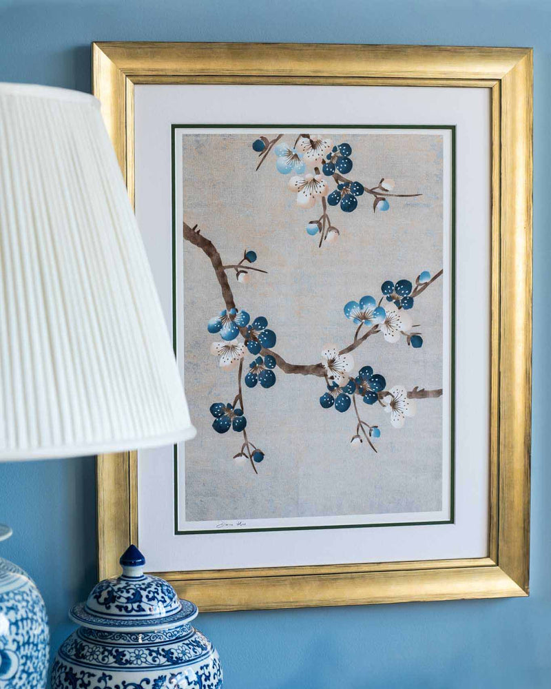 framed chinoiserie wall art print featuring Japanese-style cherry blossom branches on silver background hung on wall