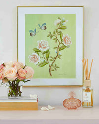 Green chinoiserie botanical style artwork with white roses two butterflies green leaves hung on wall