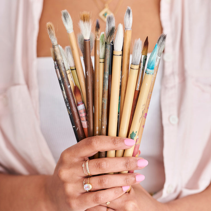 Chinoiserie artist Diane Hill holds a collection of her Chinese paintbrushes