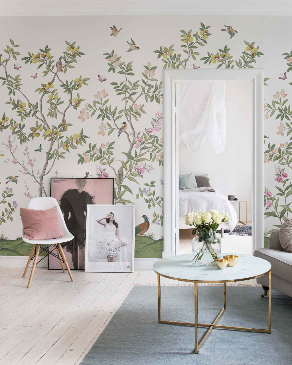 A room wallpapered in Diane Hill's Chinoiserie wallpaper design for Rebel Walls. The design is colourful, with greens, peaches, yellows and pinks on a white background.