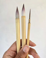 three chinese paintbrushes. chinoiserie gongbi style painting brushes two thick paint and blend brushes and one thin detail brush