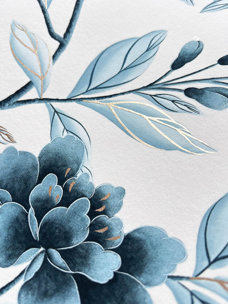 close up of regency style classic blue and white chinoiserie art print featuring flowers and branches with gold embellishment