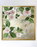 Diane Hill's original chinoiserie painting 'Mottled Lush Blooms And Butterflies (A)' in a gold frame on a plain white wall