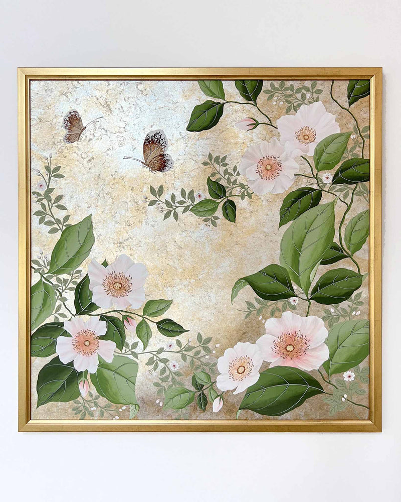 Diane Hill's original chinoiserie painting 'Mottled Lush Blooms And Butterflies (B)' in a gold frame on a plain white wall