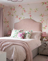 Pink chinoiserie wallpaper mural with light pink and white Japanese cherry blossom flowers in girls bedroom