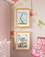 2 chinoiserie mini prints, 'Narnia' and 'Pearly Gates', framed and mounted on a bedroom wall