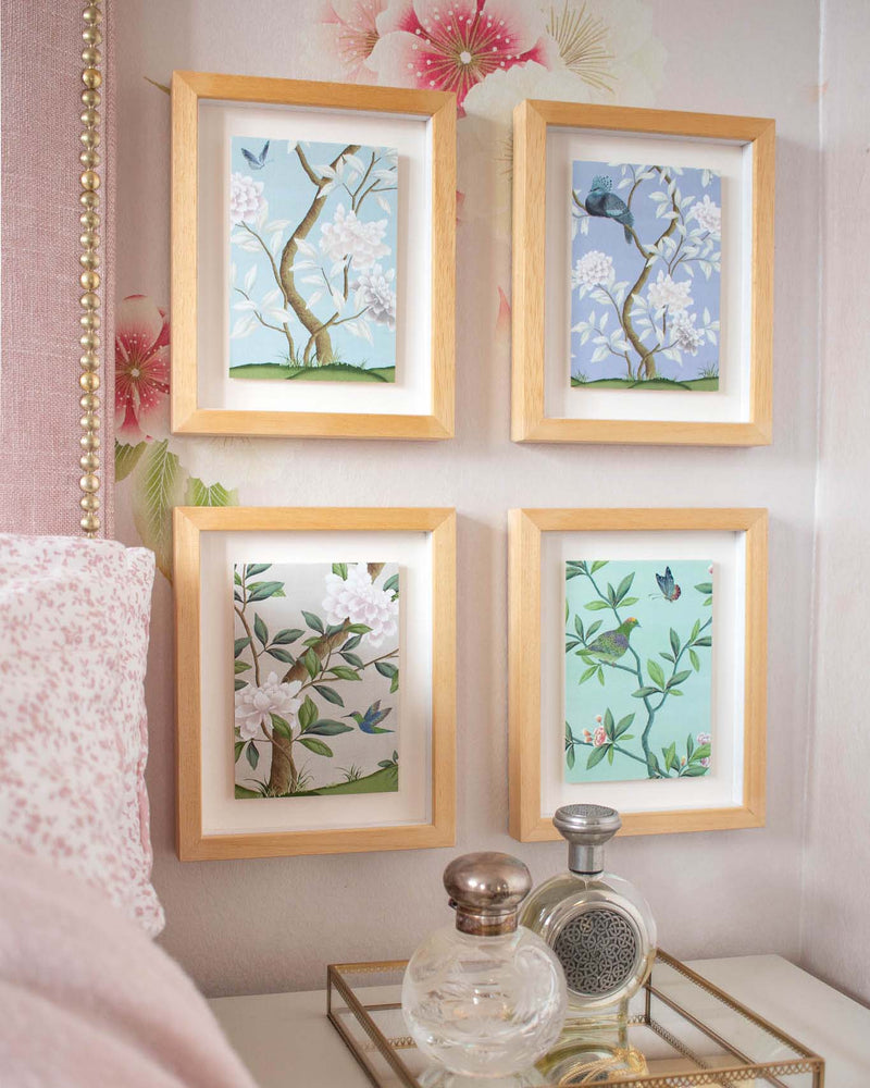 4 chinoiserie mini prints, 'Narnia' and 'Pearly Gates' 'Eden' and limited edition Lilac colourway, framed and mounted on a bedroom wall