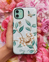 hand holding Luxury phone case featuring vintage style butterflies and flower branches with a bamboo background