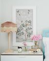 pebble blue framed chinoiserie wall art print featuring butterflies, flower branches, and bamboo hung on wall