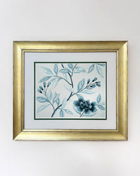 framed classic blue and white chinoiserie art print featuring flowers and branches with gold embellishment 