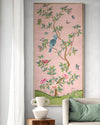 framed pink and green chinoiserie wall art panel with botanical illustrations featuring birds, butterflies, and flowers hung on wall