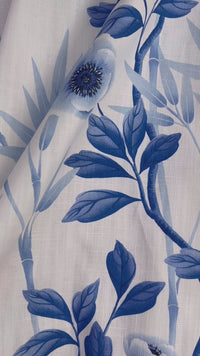 close up of classic blue and white chinoiserie fabric featuring bamboo and flowers