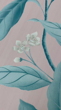 close up of pink and blue botanical wallpaper featuring chinoiserie style fruits and flowers