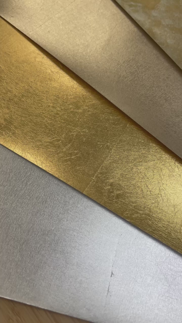 close ups of textures on metallic papers for artists in mottled gold and silver, champagne, gold, and silver leaf.