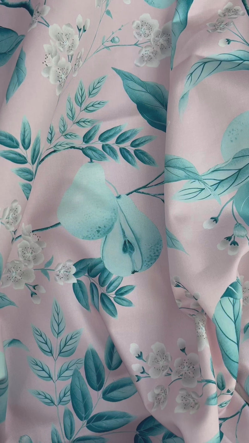 close up of pink and blue botanical fabric featuring chinoiserie style fruits and flowers