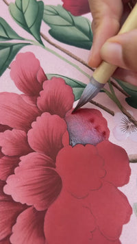 hand holding Chinese paintbrushes to paint chinoiserie style flower 