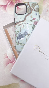 unboxing of luxury phone case featuring chinoiserie crane and mountain design