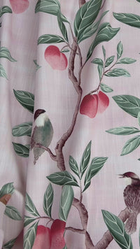 close up of pink botanical fabric featuring chinoiserie style birds, branches, and butterflies