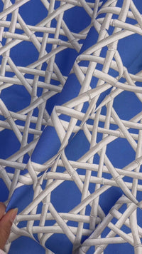 close up of blue geometric fabric featuring chinoiserie trellis design