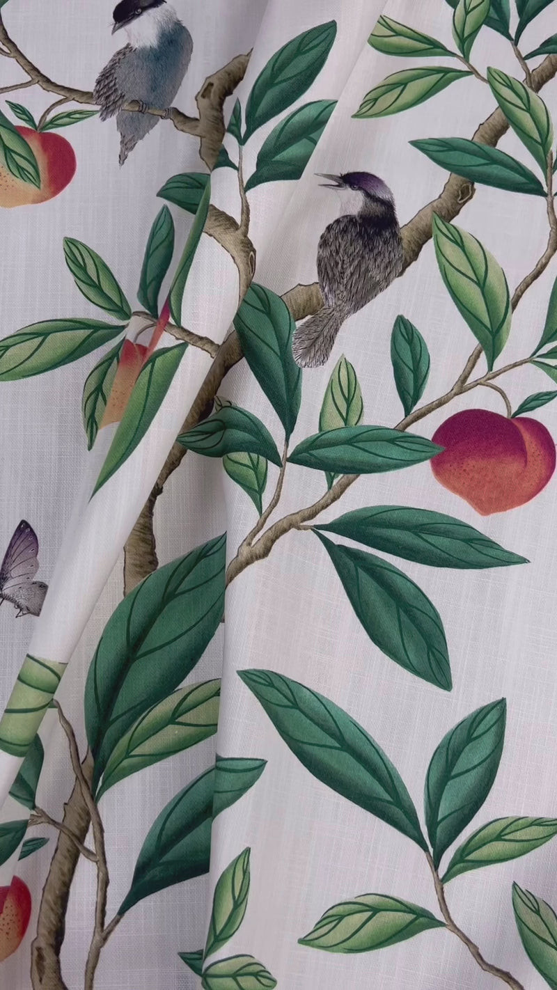 close up of botanical fabric featuring chinoiserie style birds, branches, and butterflies