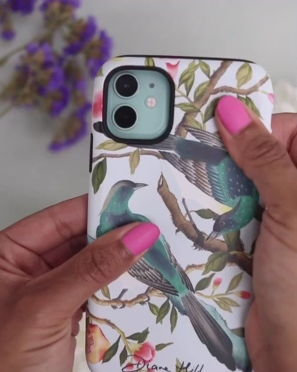 luxury chinoiserie phone case with botanical illustrations being applied to an iPhone