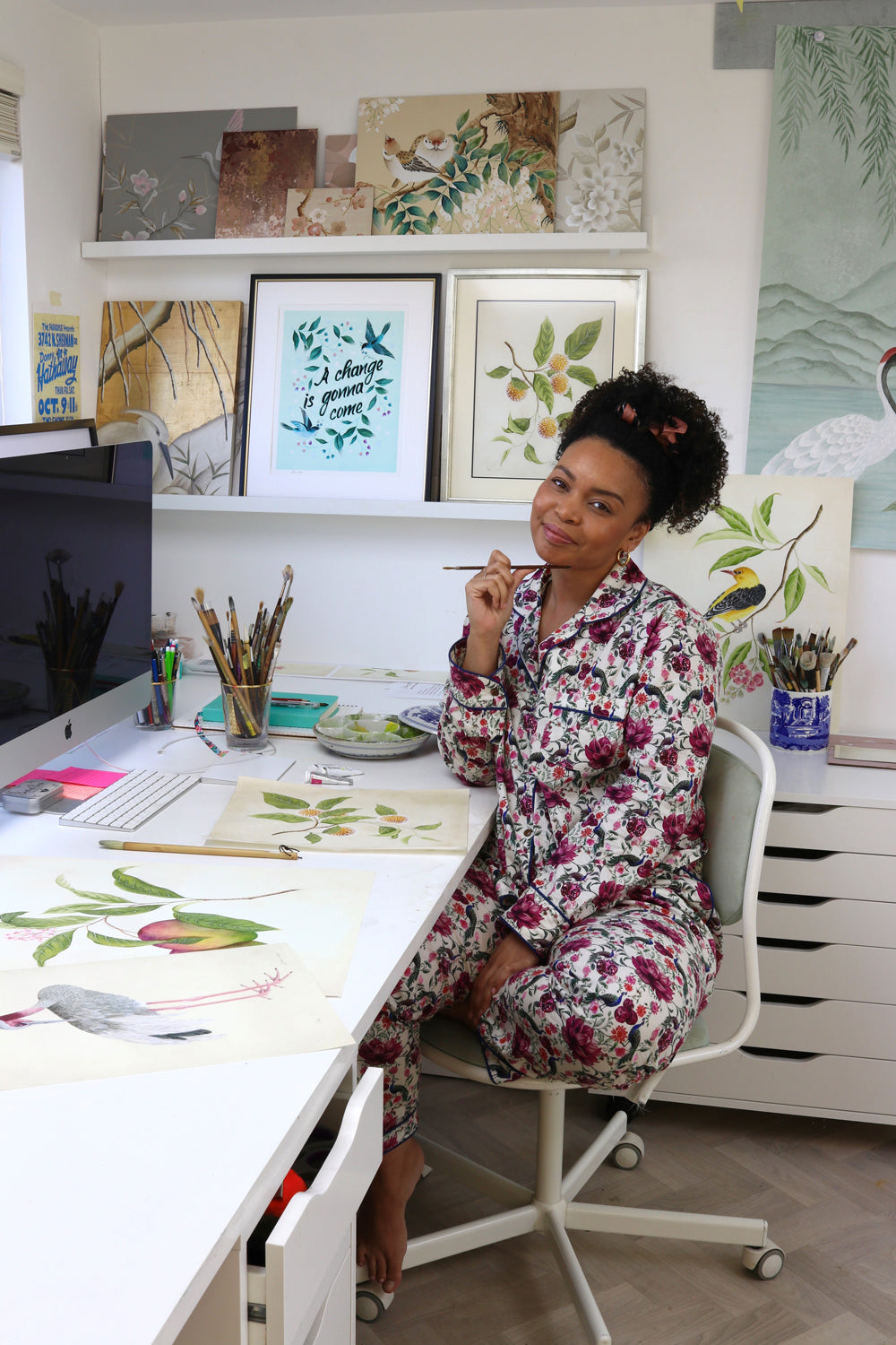 Chinoiserie artist Diane Hill sits at her desk in her London Studio wearing a stunning floral pattern