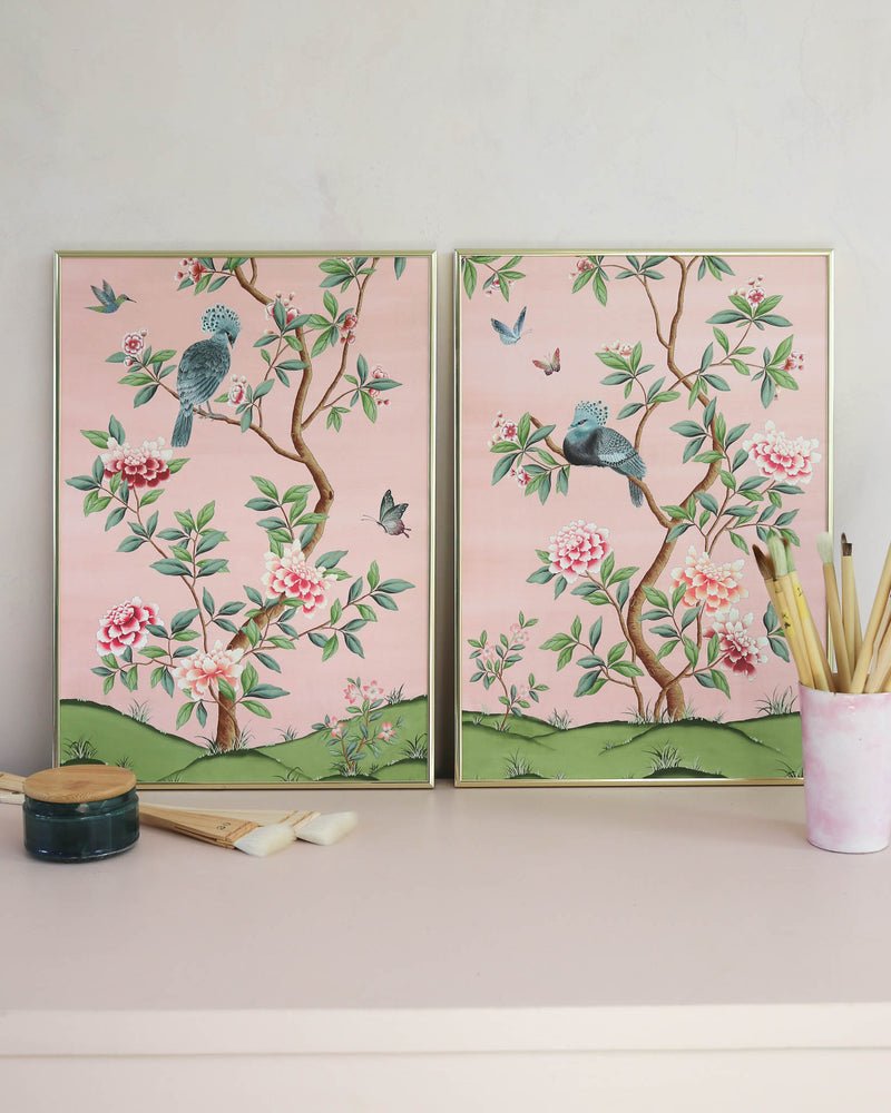 pair of 2 framed pink and green chinoiserie wall art prints with botanical illustrations featuring birds, butterflies, and flowers