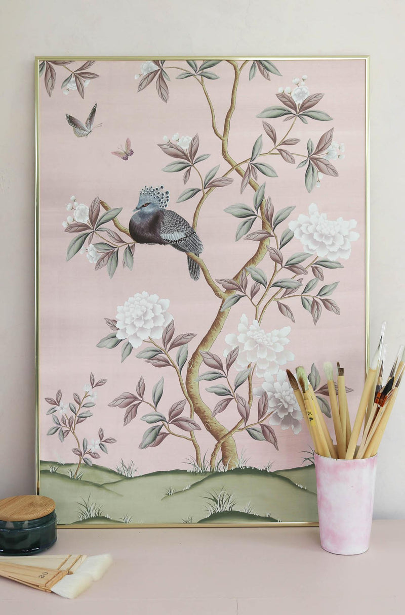 framed pink chinoiserie wall art print featuring a bird, flowers, and butterflies in Chinese painting style