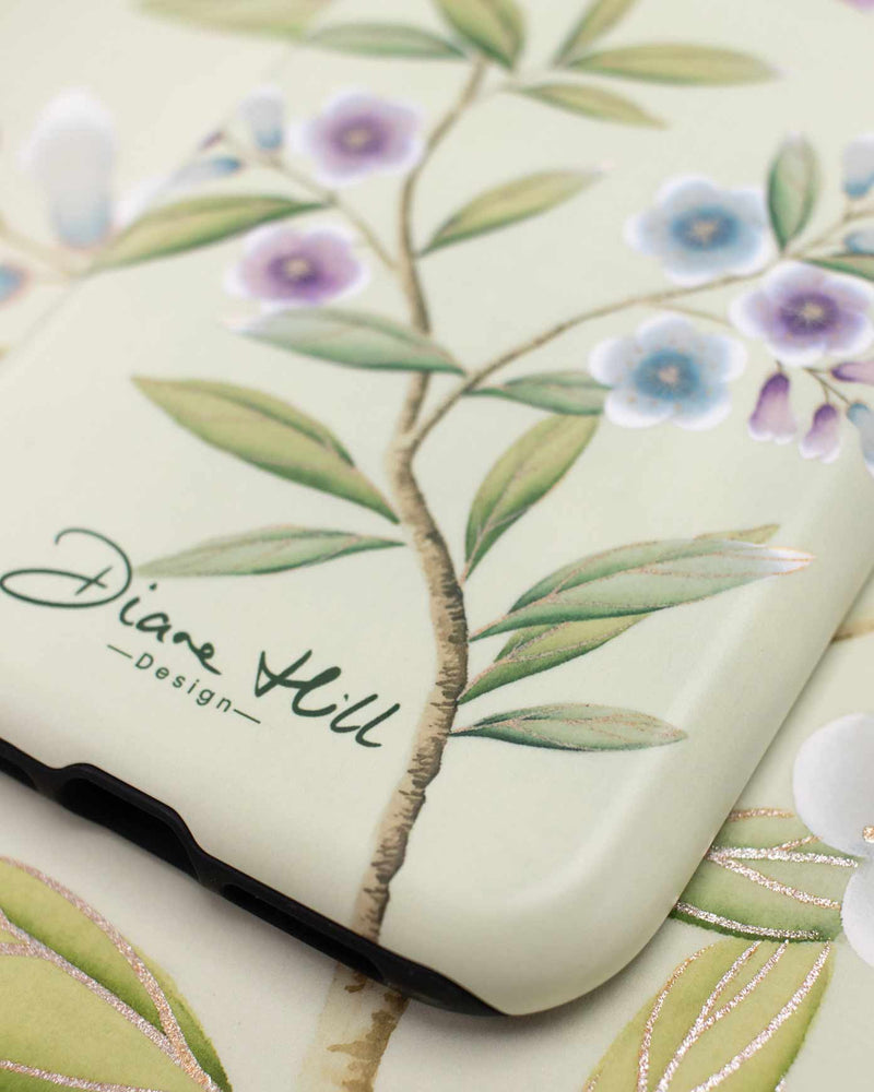 A close up of the beautiful printed details of the Carrie phone case by Diane Hill. Carrie features a pretty little bird swooping above branches of jewel-toned blossom for a fresh, contemporary feel. 