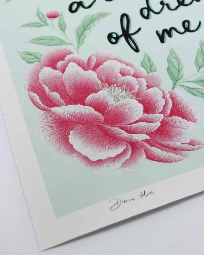 close up of blue and pink vintage-style chinoiserie wall art print featuring flowers and leaves with the quote 'dream a little dream of me'