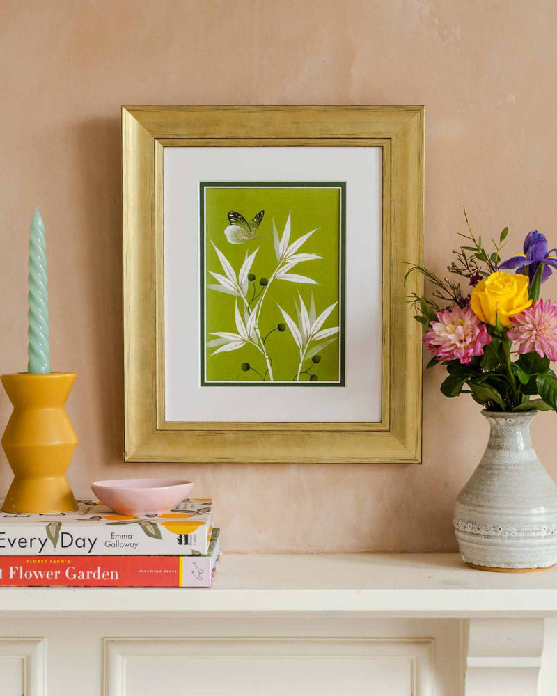 framed green and white chinoiserie wall art print featuring bamboo a butterfly hung on wall