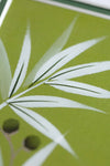 close up of green and white chinoiserie wall art print featuring bamboo a butterfly