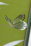 close up of green and white chinoiserie wall art print featuring bamboo a butterfly