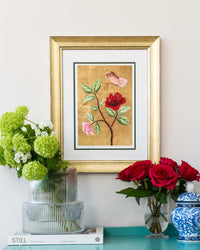 framed chinoiserie wall art print featuring vintage-style butterfly and flower branch on gold leaf background hung on wall