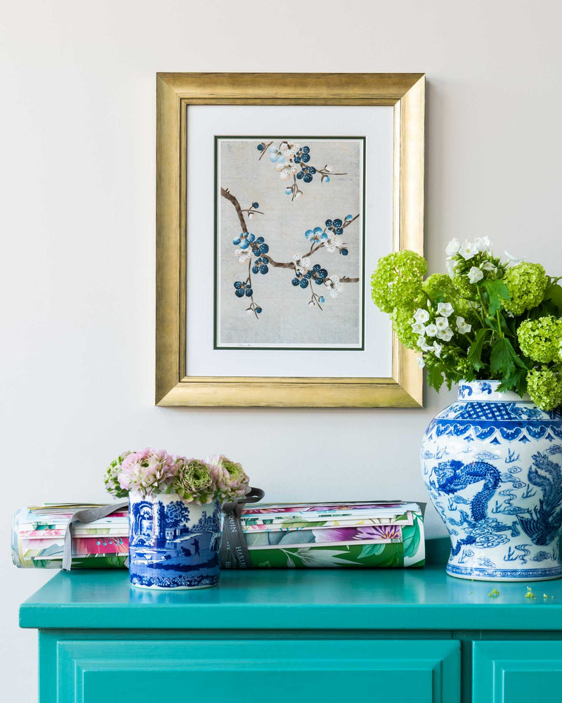 framed chinoiserie wall art print featuring Japanese-style cherry blossom branches on silver background hung on wall