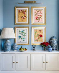 set of 4 colourful framed chinoiserie wall art prints featuring vintage-style butterflies, blossoms, and flower branches displayed as gallery wall