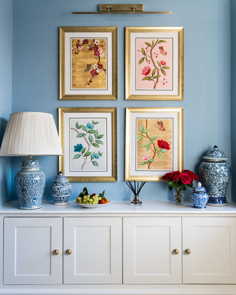 set of 4 colourful framed chinoiserie wall art prints featuring vintage-style butterflies, blossoms, and flower branches displayed as gallery wall