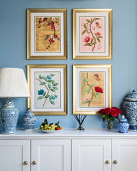 set of 4 colourful framed chinoiserie wall art prints featuring vintage-style butterflies, blossoms, and flower branches displayed as gallery wall