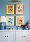 set of 4 colourful framed chinoiserie wall art prints featuring vintage-style butterflies, blossoms, and flower branches displayed as gallery wall