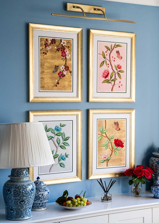 set of 4 colourful framed chinoiserie wall art prints featuring vintage-style butterflies, blossoms, and flower branches displayed as gallery wall