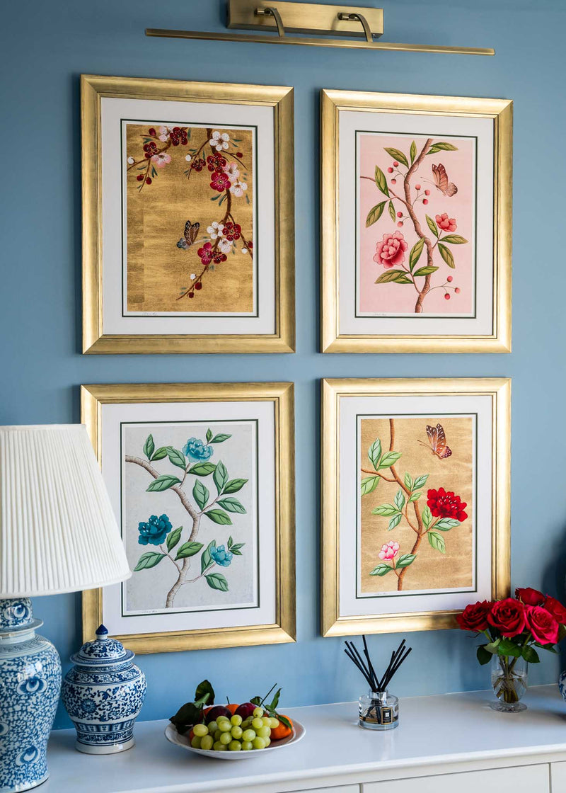 set of 4 colourful framed chinoiserie wall art prints featuring vintage-style butterflies, blossoms, and flower branches displayed as gallery wall