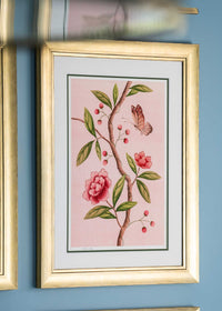 framed chinoiserie wall art print featuring pink vintage-style butterfly and flower branch on pink background hung on wall