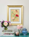 framed chinoiserie wall art print featuring vintage-style butterfly and flower branch on gold leaf background hung on wall