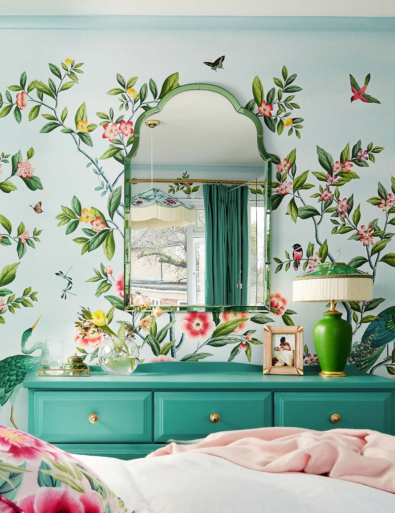 blue classic chinoiserie wallpaper featuring chinese illustration style peacocks, birds, and botanicals in grandmillennial bedroom